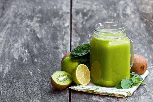 Fresh  smoothie with green fruits in a glass jar mug on wooden table  - Fotografie, Obrázek