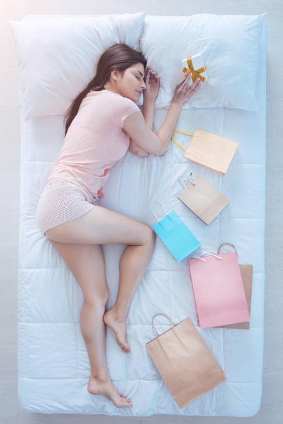 Relaxed young woman taking nap after buying gifts - Fotoğraf, Görsel