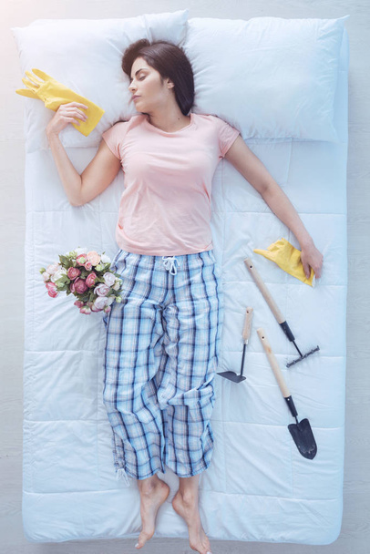 Beautiful woman sleeping after gardening all day - 写真・画像