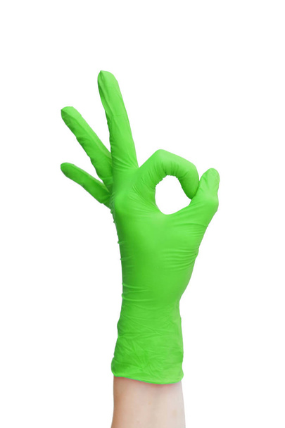 Ok sign  made of  green medical gloves. Fingers Okay symbol - Фото, изображение
