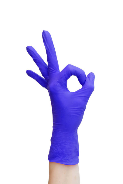 Ok sign  made of  purple medical gloves. Fingers Okay symbol - Foto, Bild