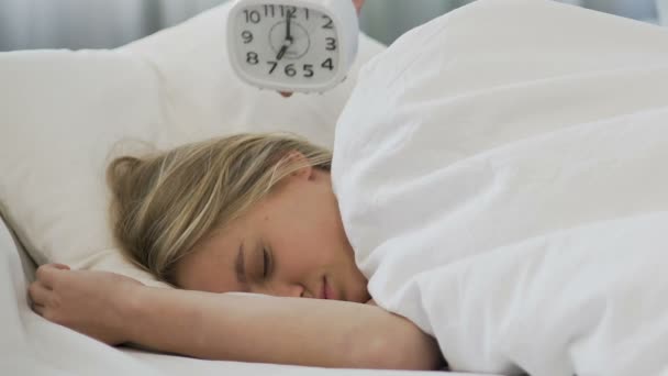 School girl ignoring alarm clock, sleeping in morning and missing lessons - Felvétel, videó