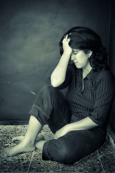 Very depressed woman sitting on a corner - Fotografie, Obrázek