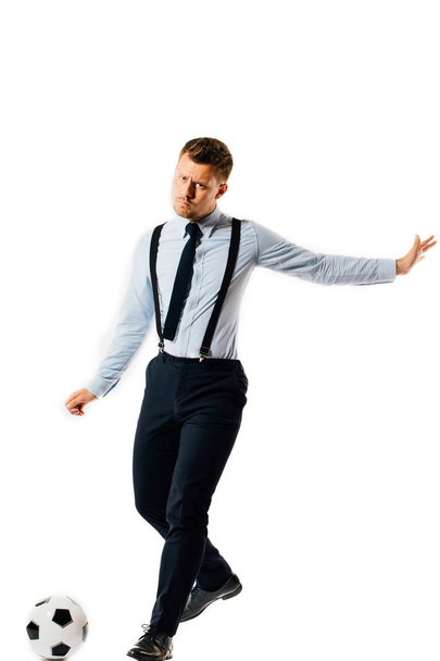 young handsome businessman manager kicking a soccer ball on white background isolated. - Foto, Bild