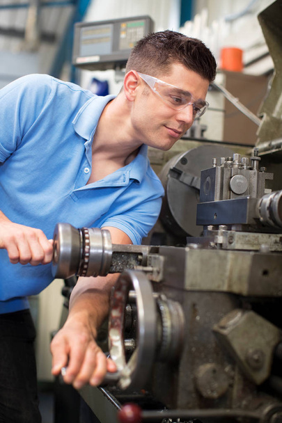 Male Engineer Operating Lathe In Factory - Photo, Image