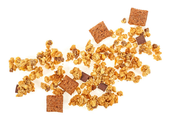 Muesli pile with chocolate isolated on white background, top view. Crunchy granola. - 写真・画像