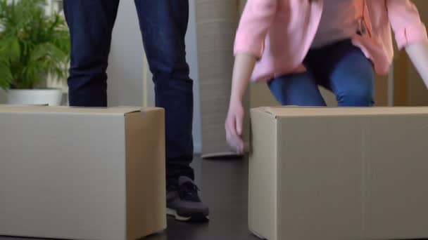 Young couple moving out apartment, carrying carton boxes, eviction through debts - Video