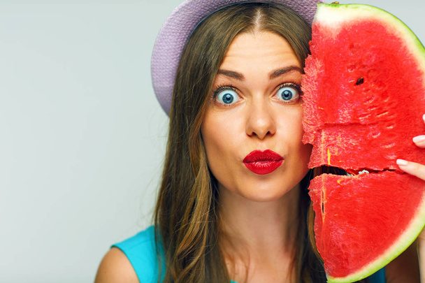 surprised woman giving kissing lips and holding watermelon - Foto, imagen