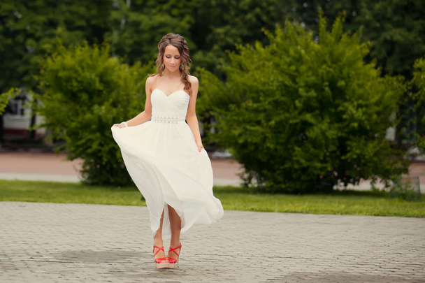 beautiful young woman in luxury elegant dress posing in summer park  - Fotó, kép