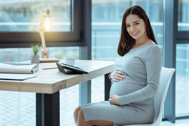 Cheerful female person expecting baby - Фото, зображення