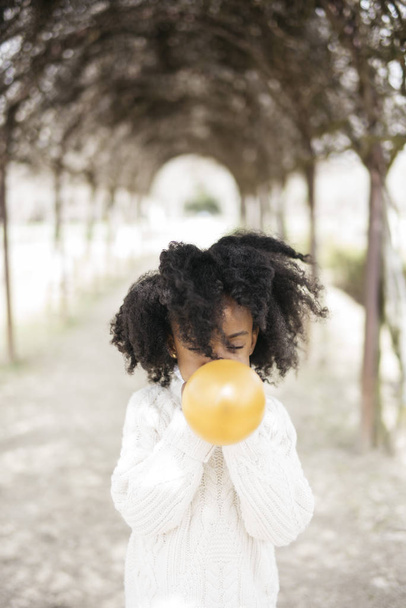 Girl blowing balloon outside - Photo, Image