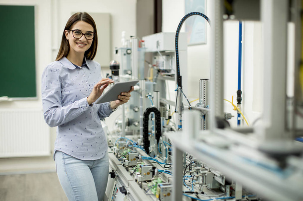 Portrait of  female electronic engineer using  digital tablet  in the laboratory - Φωτογραφία, εικόνα