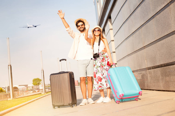 Love couple at the airport say goodbye to a friends and going to vacation, holiday, honeymoon, adventure - Foto, immagini