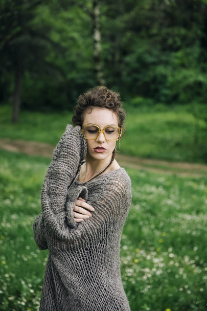 Pretty young woman with eyeglasses outdoors in the forest - Foto, imagen