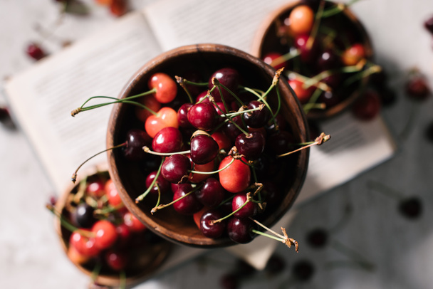 top view of tasty healthy organic cherries in bowl, selective focus  - Fotó, kép