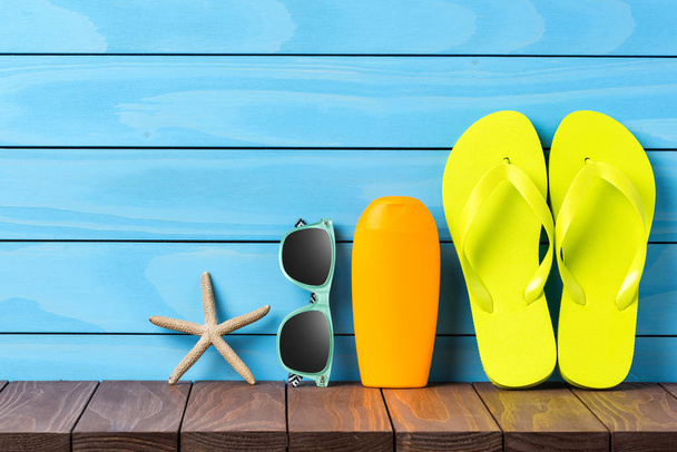 Beach accessories on blue wooden background. Close up - Photo, image