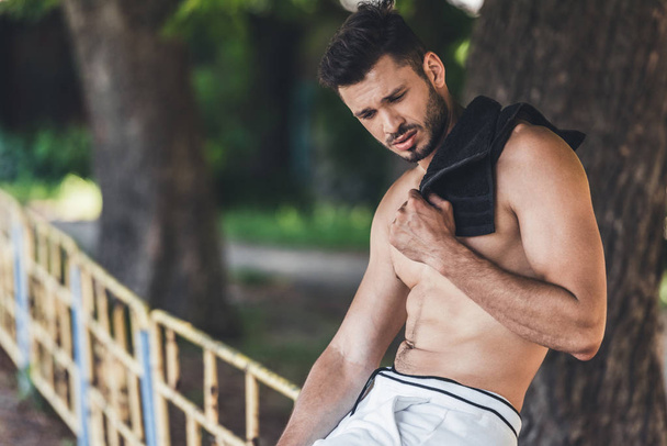 tired shirtless male athlete resting after workout with towel on shoulder  - Fotoğraf, Görsel