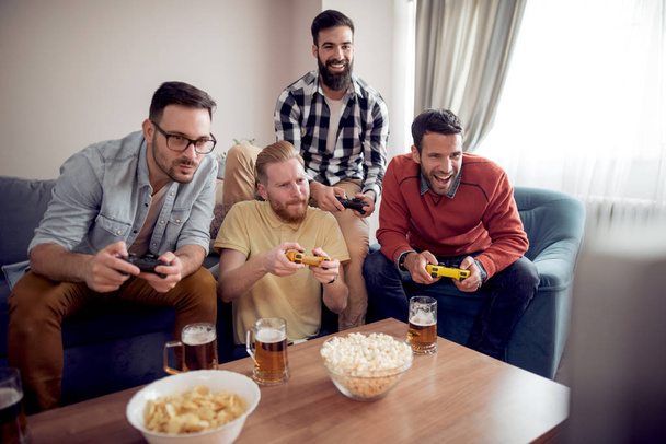 Група друзів, які грають у відеоігри, отримують задоволення разом
. - Фото, зображення