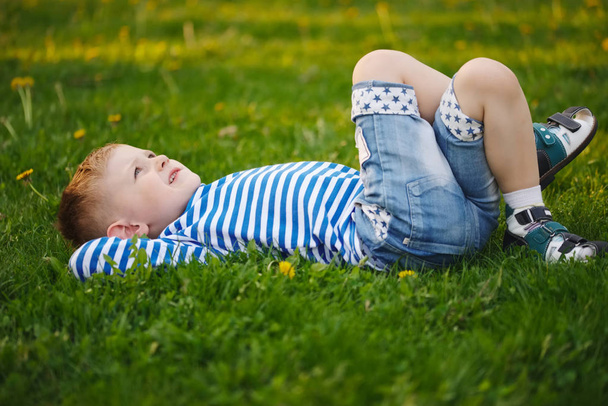 little boy lying on the grass - Photo, image