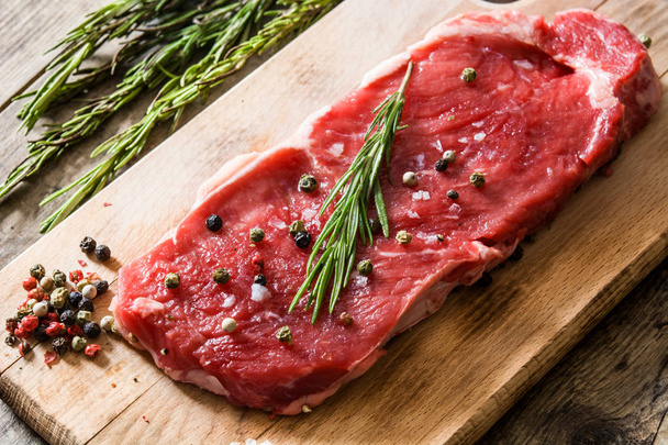 Raw beef steak with spicy ready to be cooked on wooden table.  - 写真・画像
