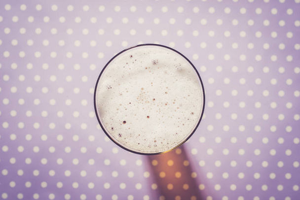 Beer glass on purple checkered background - Photo, image