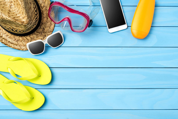 Beach or summer accessories on blue wooden background - Valokuva, kuva