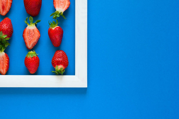 Minimalism. Strawberry martix. Masterpiece in wooden frame. Top view. Flat lay. - Photo, Image