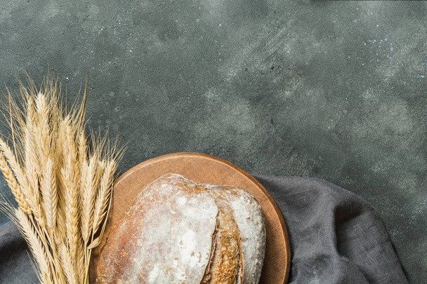 Homemade fresh rye bread with sunflower seeds on dark rural background. Close up. Space for text. - Zdjęcie, obraz