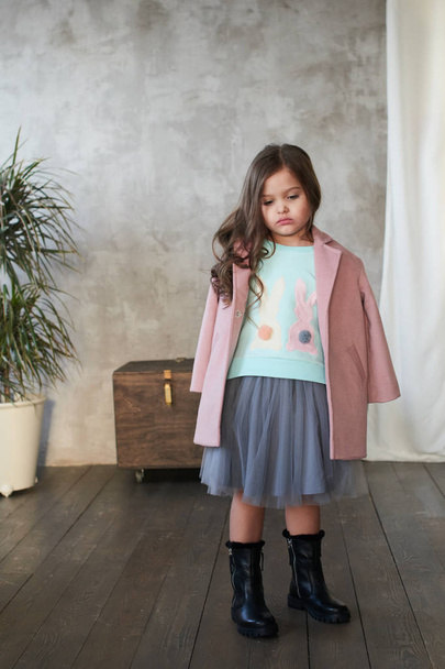 Stylish little girl wearing pink coat posing in studio, Children lookbook concept  - Foto, imagen