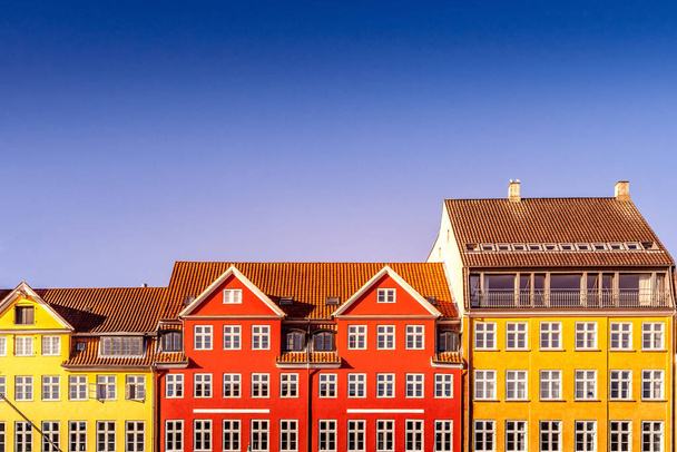 beautiful colorful historical houses against blue sky in copenhagen, denmark - Photo, Image