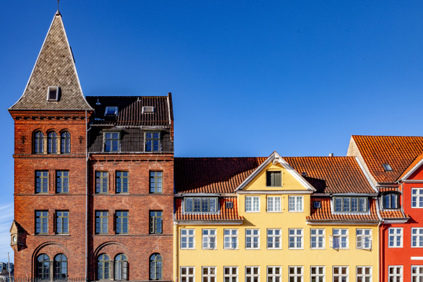 beautiful historical buildings against blue sky in copenhagen, denmark - Photo, Image