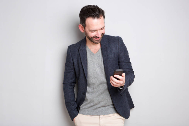 Portrait of fashionable man looking at cellphone - Photo, Image