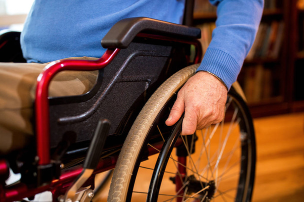Senior mature man at wheelchair close up at home - 写真・画像