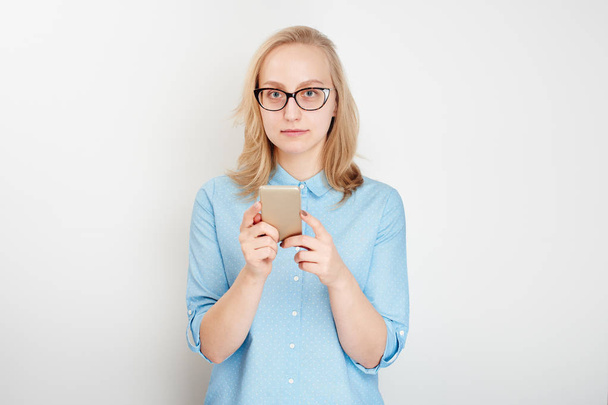 blonde businesswoman using smartphone isolated on white background - Valokuva, kuva