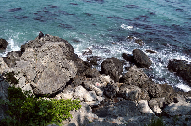 fisherman on the rocks of sea in Busan, South korea - Φωτογραφία, εικόνα