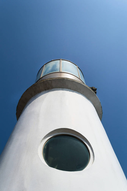 view from below on The Dongbaekseom Lighthouse in Dongbaek park on sunny day - Foto, imagen