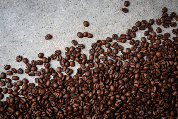 Roasted coffee beans on gray stone background. Close up - Fotoğraf, Görsel