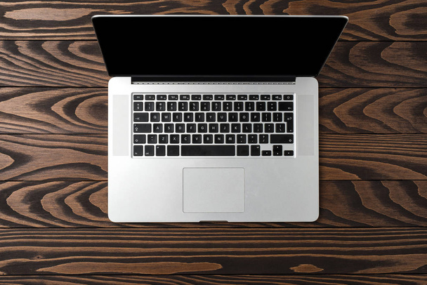 Laptop on dark wooden background - Foto, imagen