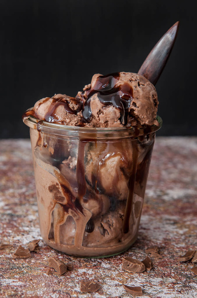 Chocolate ice cream with chocolate sauce in glass jar - Fotó, kép