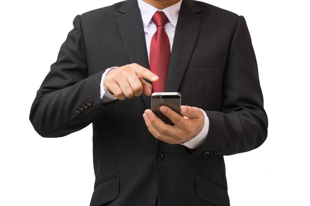 Businessman in the suit is using smartphone - Φωτογραφία, εικόνα