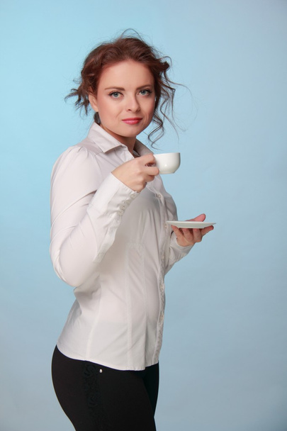 Woman drinking from a cup of coffee - Photo, Image