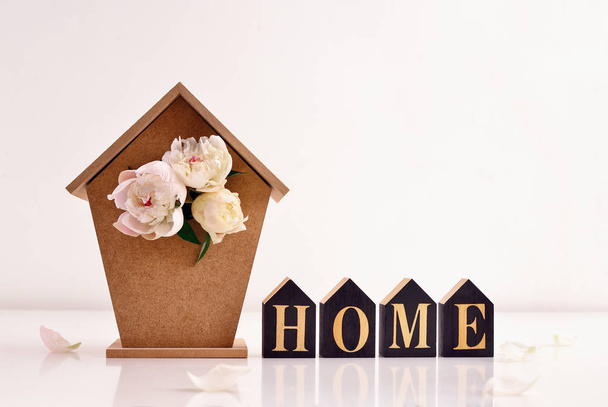 Home decor concept card template, vista frontale di una casa di uccelli con peonie bouquet al suo interno
  - Foto, immagini