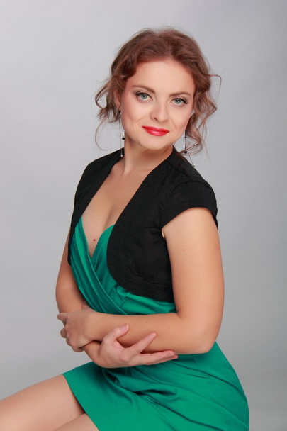 Beautiful woman in a short green dress - Fotó, kép