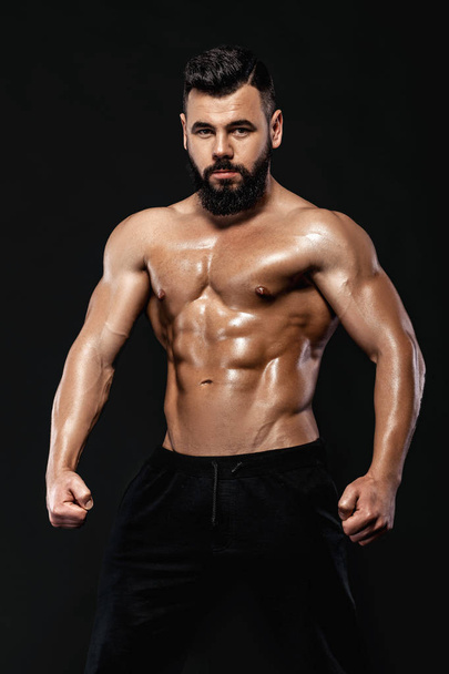 strong bodybuilder posing in studio - Photo, Image