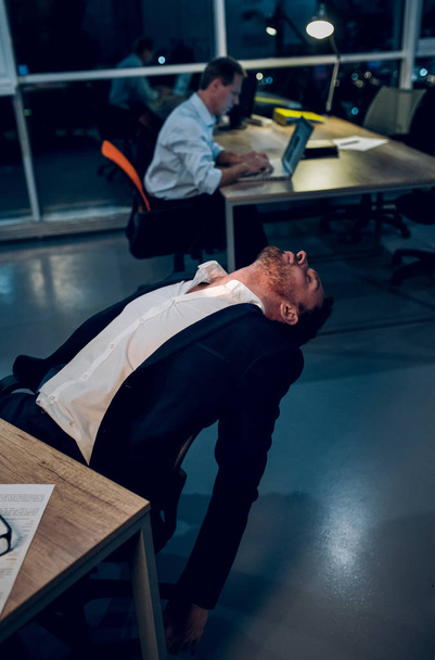 Businessman falling asleep during work. - Фото, изображение