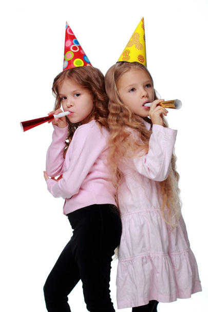 Pretty party girls blowing noisemakers - Foto, Imagen