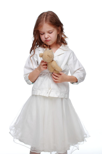 Little girl and a fluffy toy - Foto, imagen