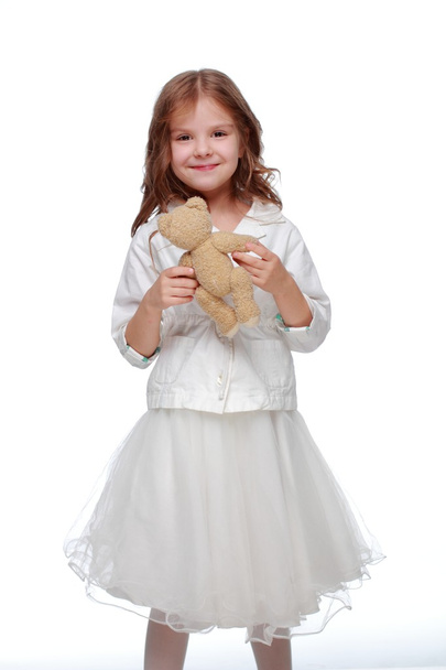 Little girl and a fluffy toy - Фото, зображення