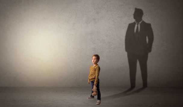 Little boy with businessman shadow - Φωτογραφία, εικόνα