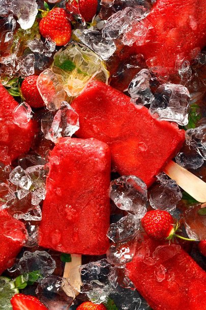 Ice popsicles. Strawberry ice pops, delicious and healthy homemade dessert, top view. - Photo, Image
